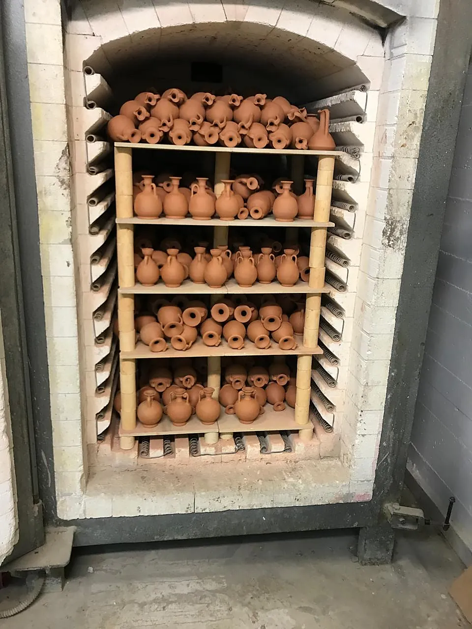 The atelier kiln, stacked with terracotta vessels